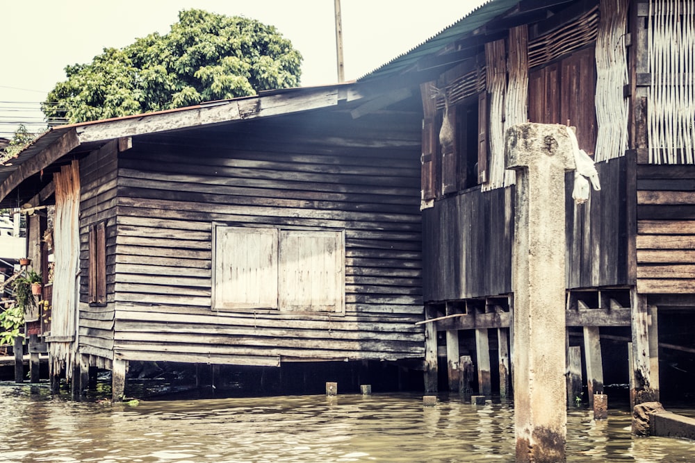 brown and gray house beside body of water