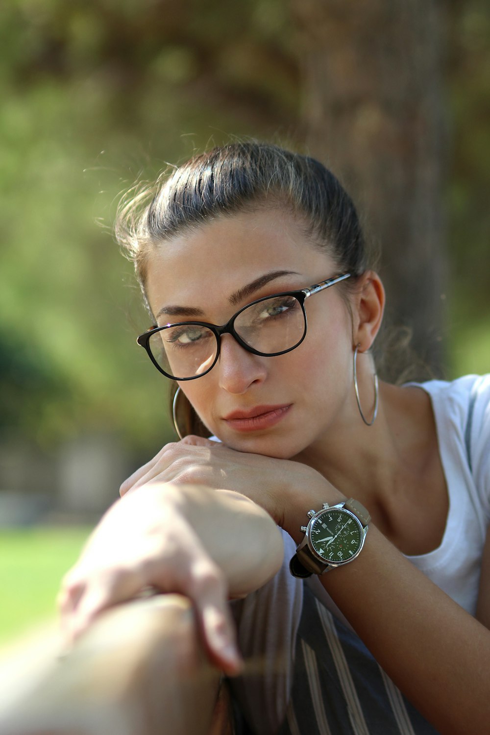 woman leaning on wood during daytime