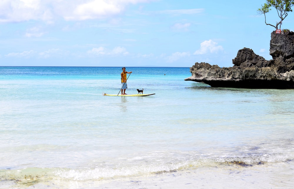 person riding kayak on sea during daytime