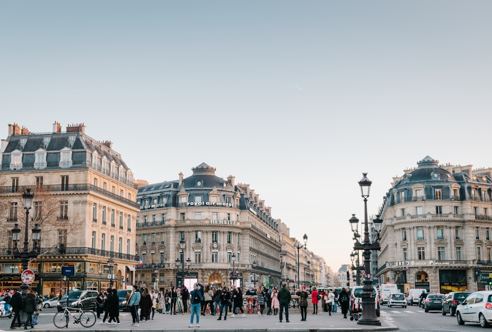 people walking on street beside buildings