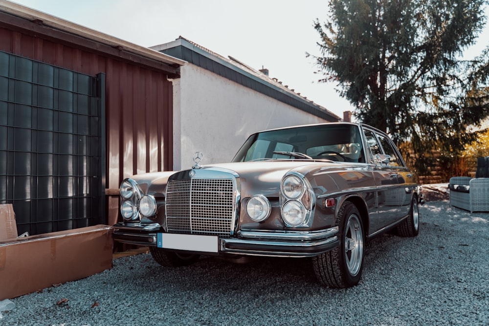 classic grey vehicle parked near building