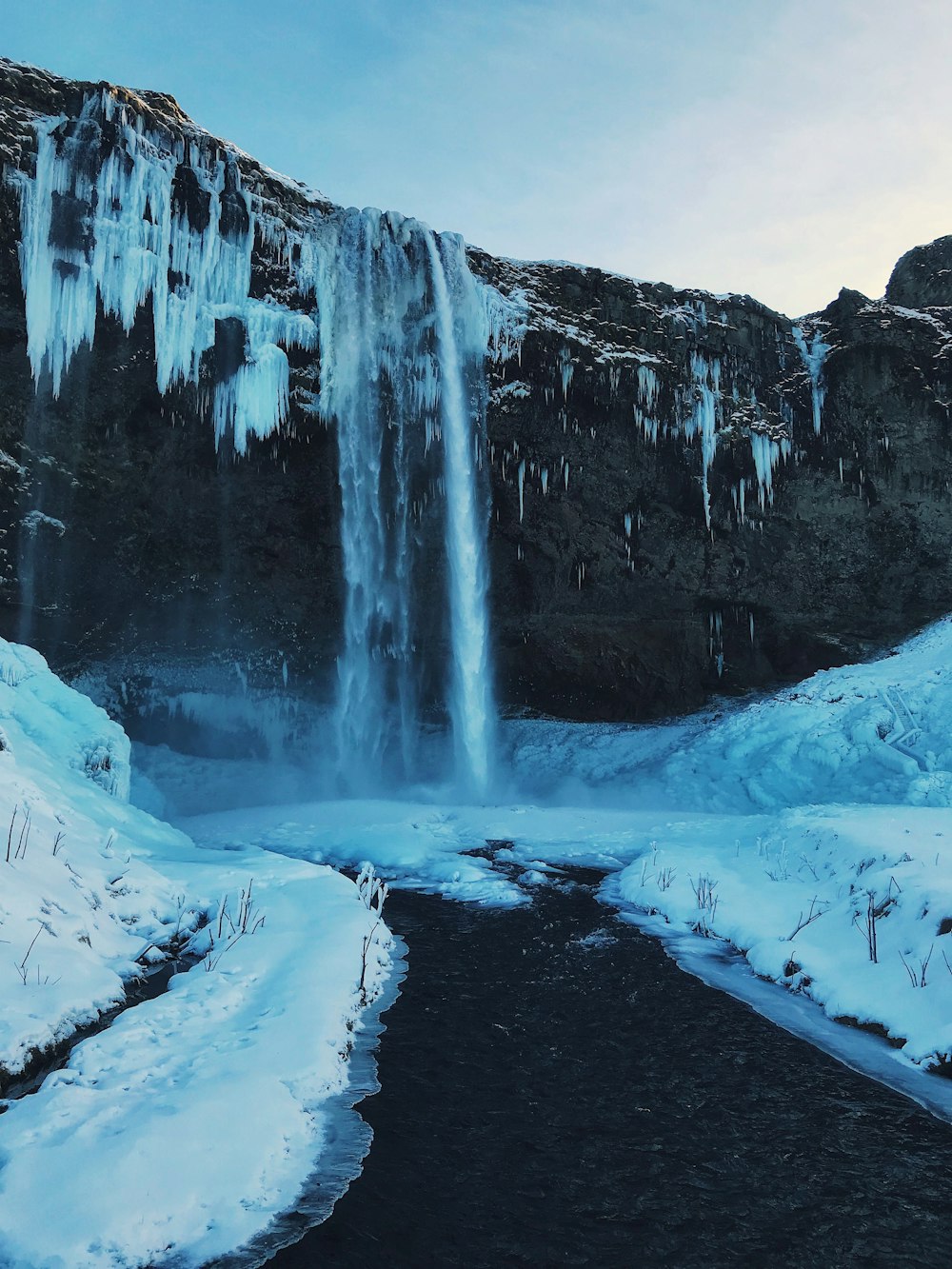 snow covered waterfalls during daytime