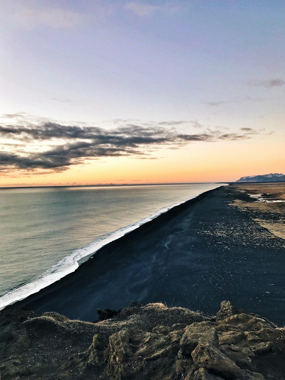 a view of the ocean from the top of a hill