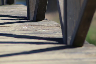 Close-up of a freshly pressure-washed wooden deck glistening under sunlight.