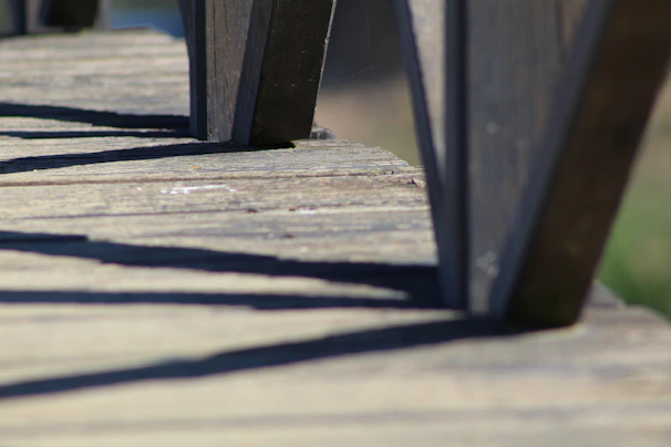 Close-up of textured wood-plastic composite decking with frost-resistant finish under soft morning light.