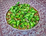 Rustic wooden bowls containing sesame seeds and karupukavuni arisi grains.