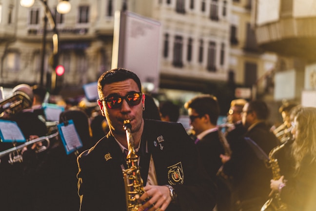 Johnny Mag Sax passionately playing saxophone at a sunset wedding ceremony.