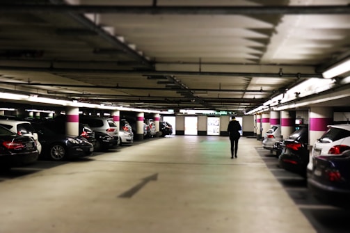 man standing between cars