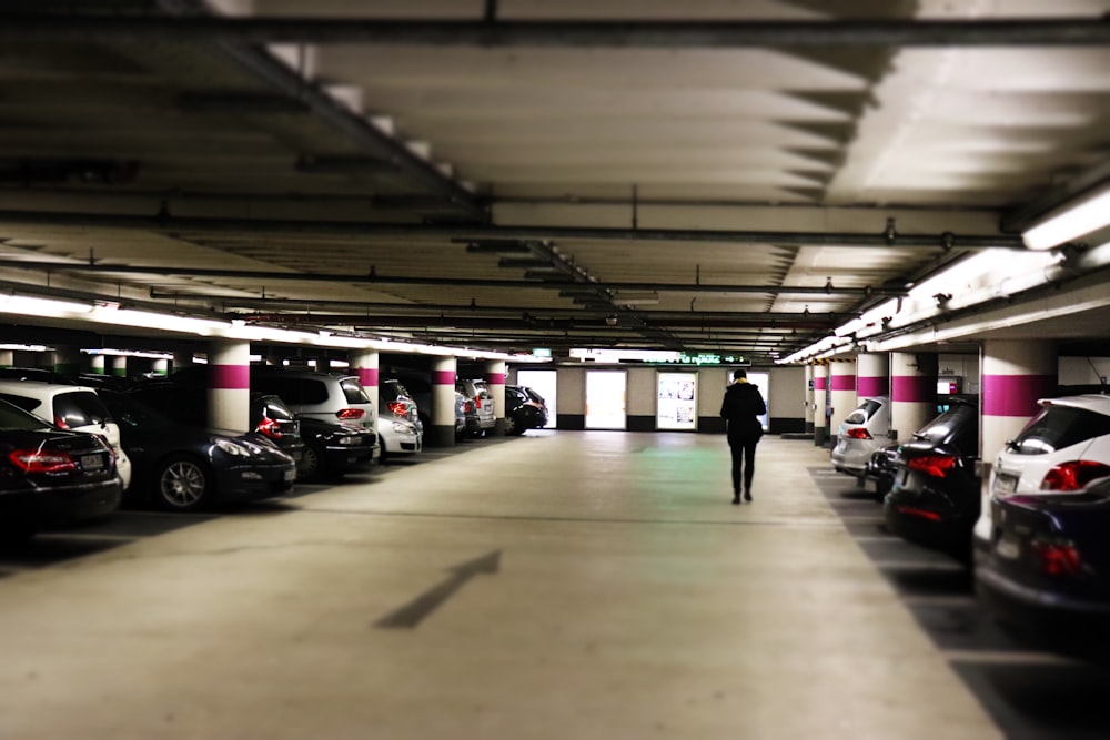 man standing between cars