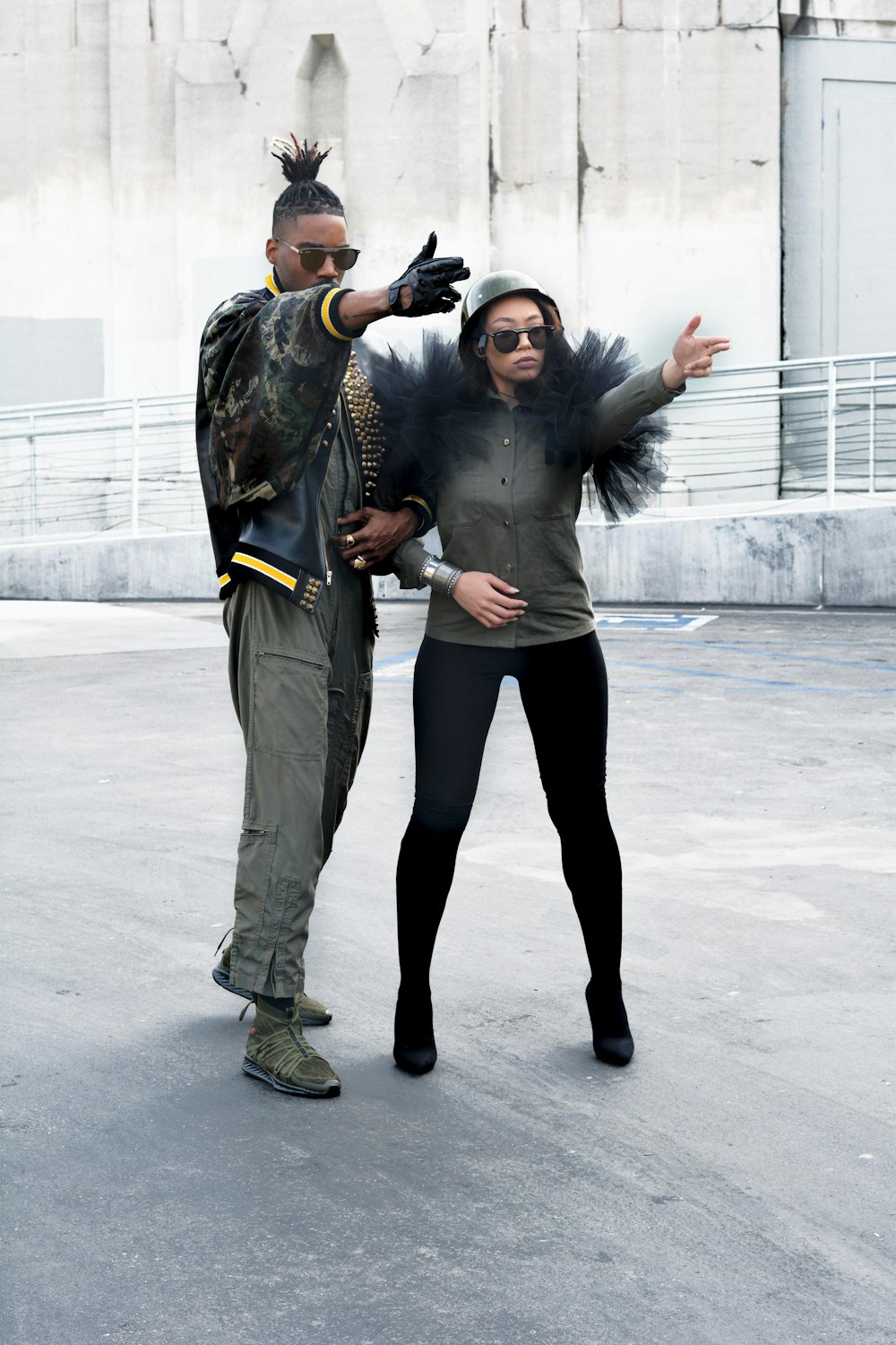 man and woman stand on concrete flooring