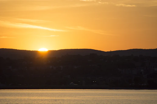 Sunset over the serene countryside of Palencia with rolling hills and a winding river.