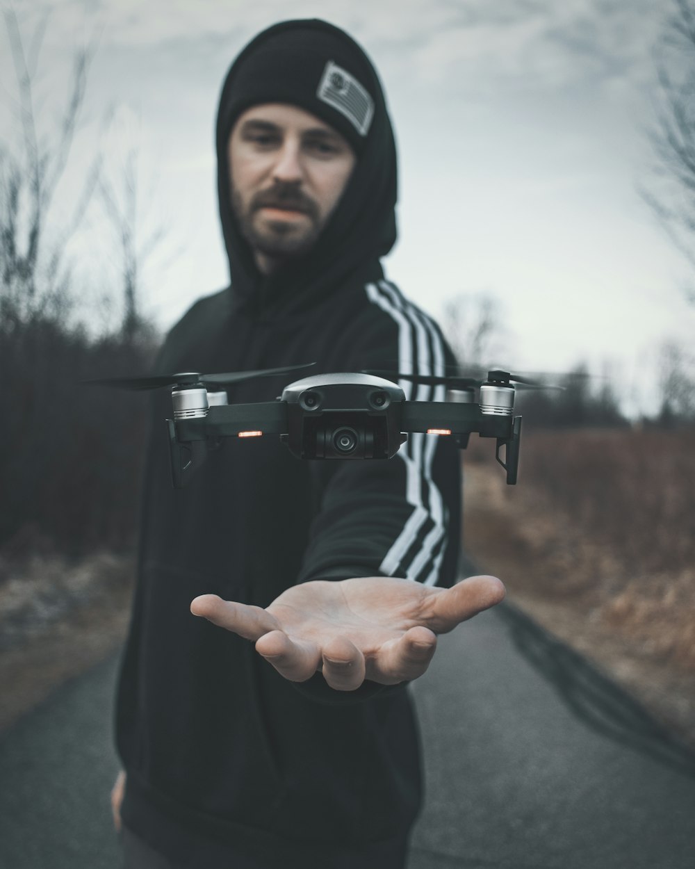 black drone above man's hand