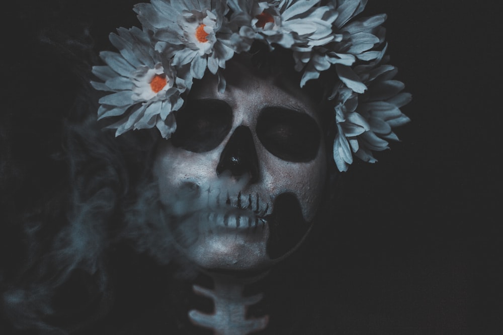 white and black skull with flower headband illustration