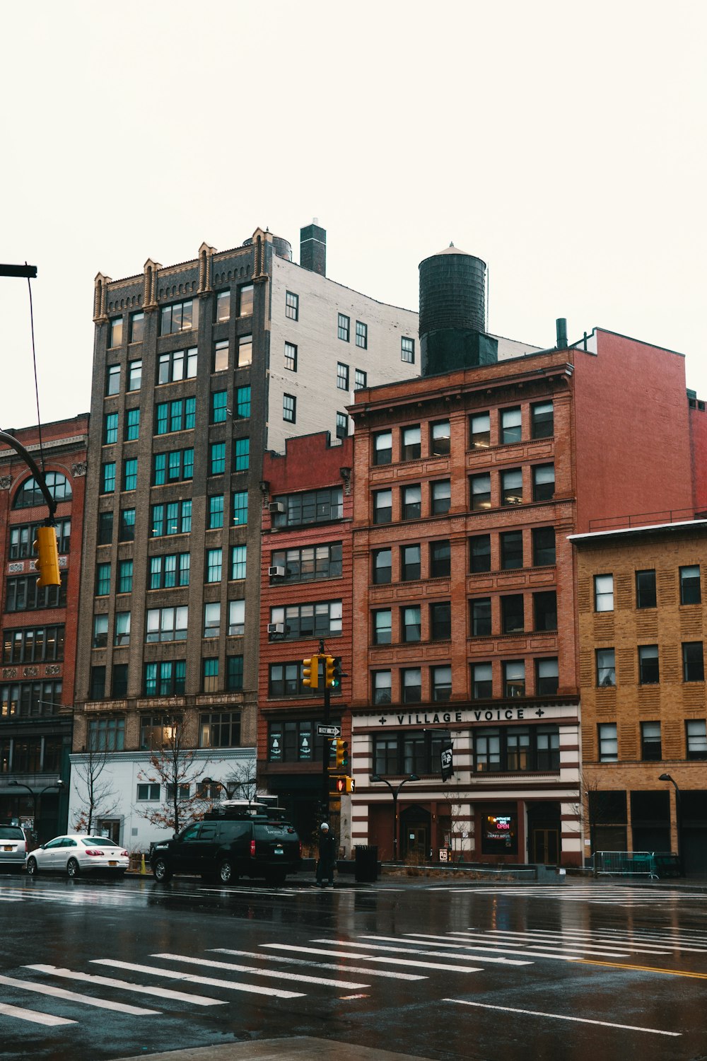 two black and white vehicles passing buildings during daytime