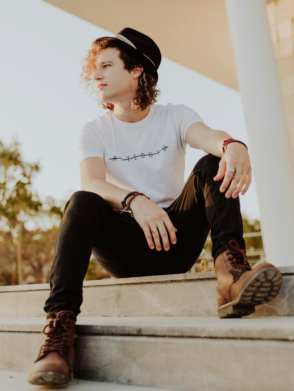 man in white shirt and blue denim jeans