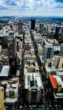 Aerial view of a bustling city with various properties.