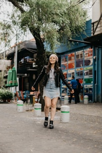 Young woman confidently walking in stylish streetwear.