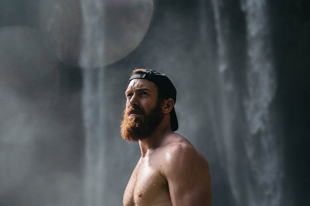 topless man wearing black fitted cap