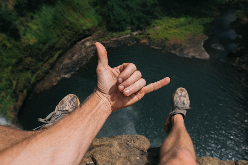 person showing hang-loose hand sign