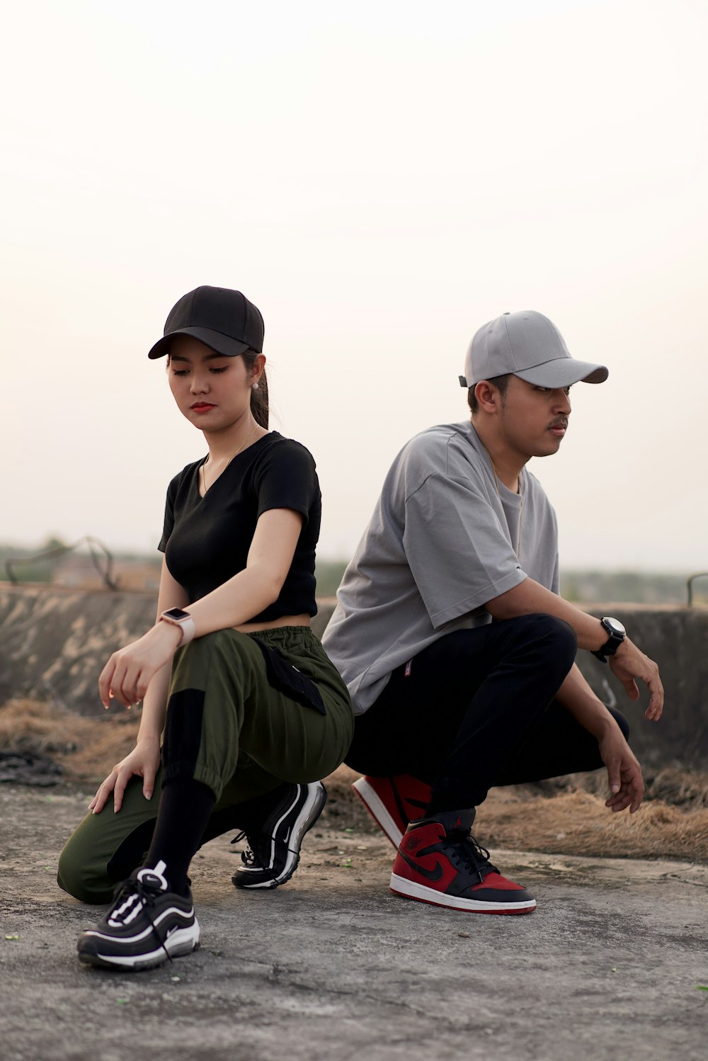two man and woman wearing fitted caps