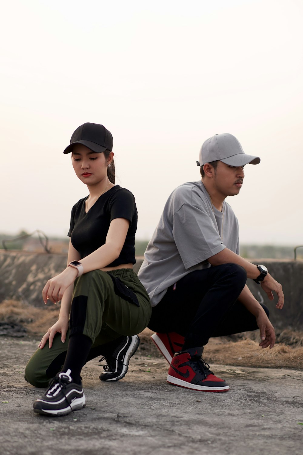 deux hommes et une femme portant des casquettes ajustées