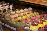 A dessert display featuring assorted pastries and fruit tarts with delicate decorations.