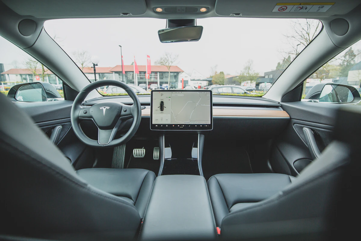 The interior of a Tesla looking across the dashboard