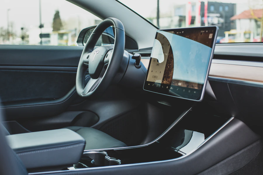 An illuminated center console touchscreen inside a Tesla