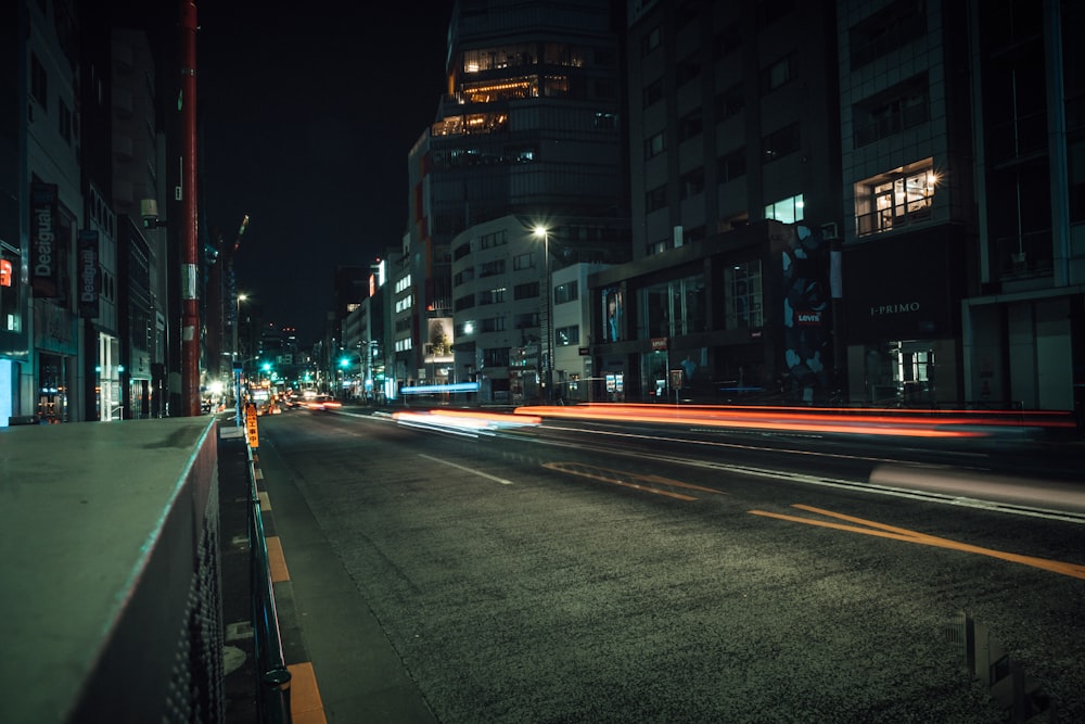 lighted street beside buildings