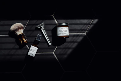 A modern grooming kit arranged neatly with electric shavers and trimmers, highlighted by silver and blue lighting.