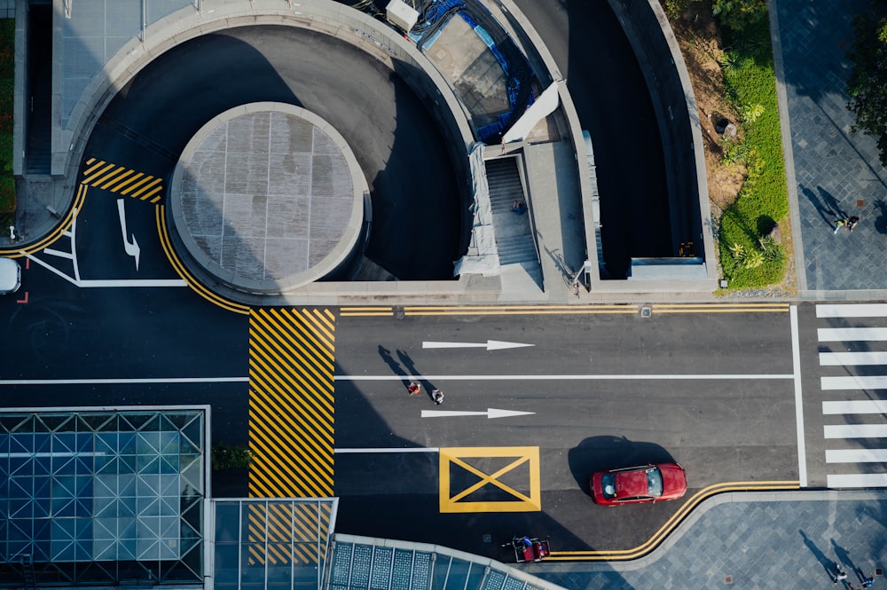 aerial photography of red car on road