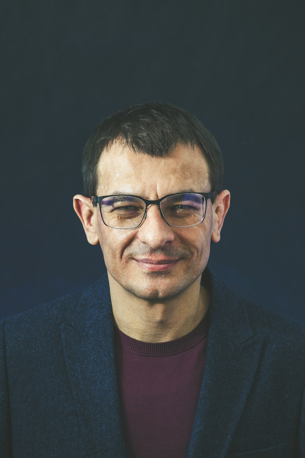 smiling man wearing black framed eyeglasses