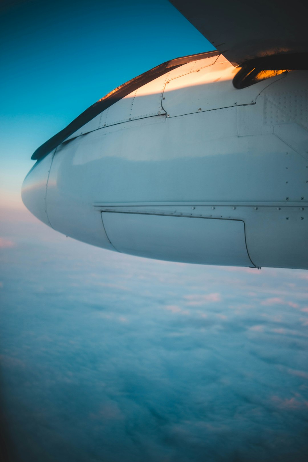 white airplane above white clouds