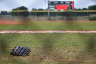 leather baseball mitt on ground