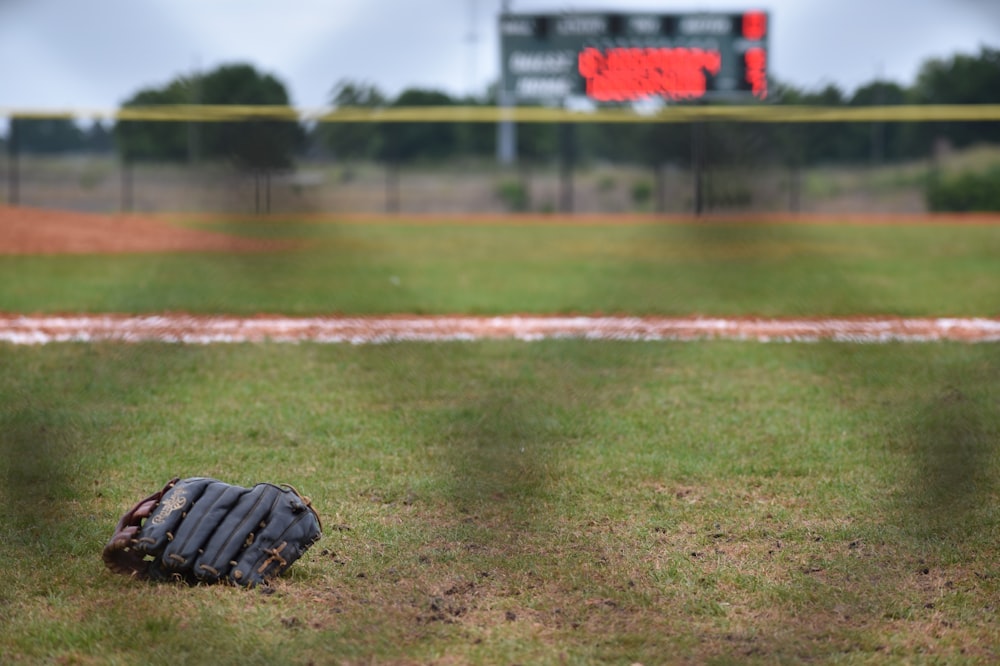 leather baseball mitt on ground