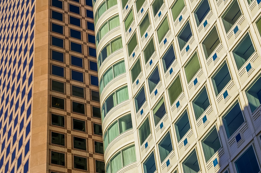 low angle photo of curtain glass wall buildings