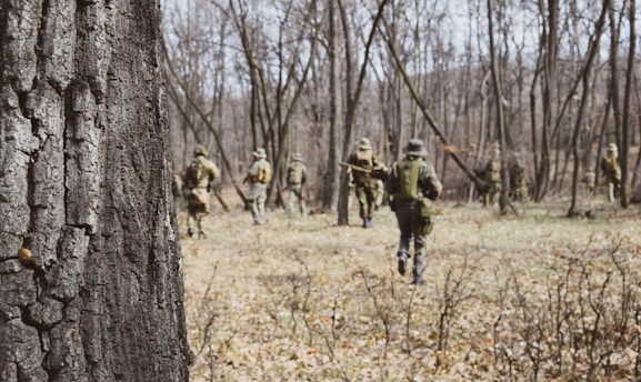soldiers walking near trees