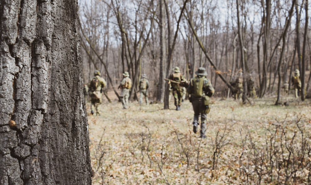 soldiers walking near trees