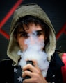 man in hoodie vaping