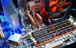 computer motherboard with RAM sticks and aftermarket cooling system