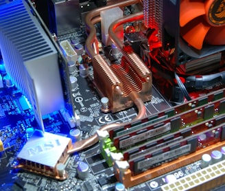computer motherboard with RAM sticks and aftermarket cooling system