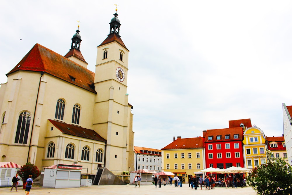 people standing near brown concrete church