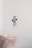 A LEGO figure dressed as a stormtrooper appears to be in mid-air above an outstretched hand. The background is a light, neutral color, giving a sense of space and focus on the figure.