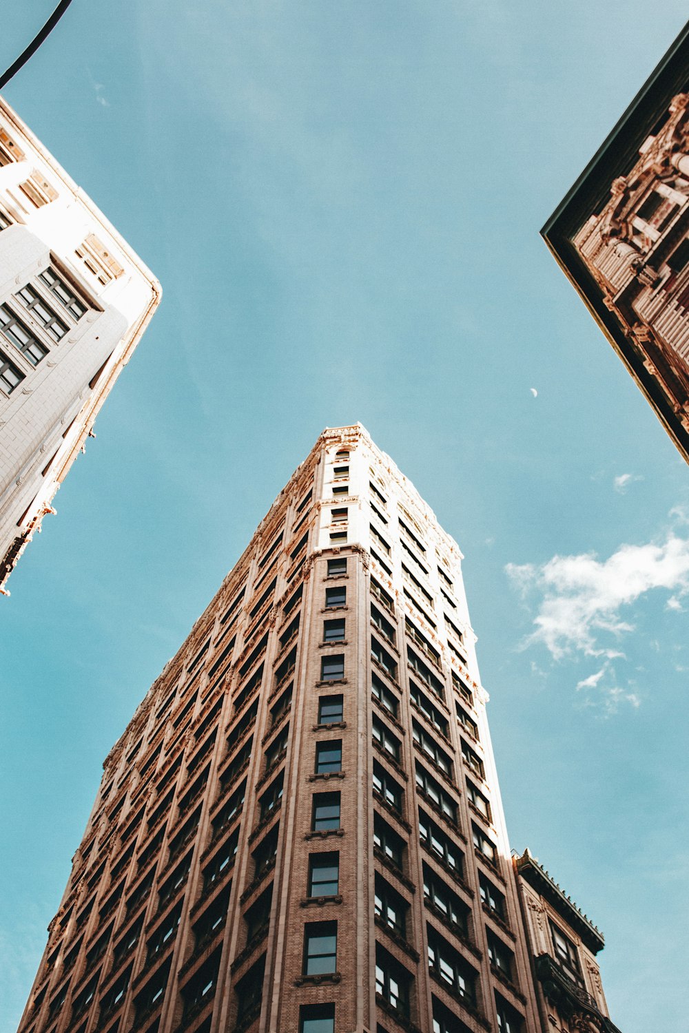 low angle photo of concrete building under clear blue sky