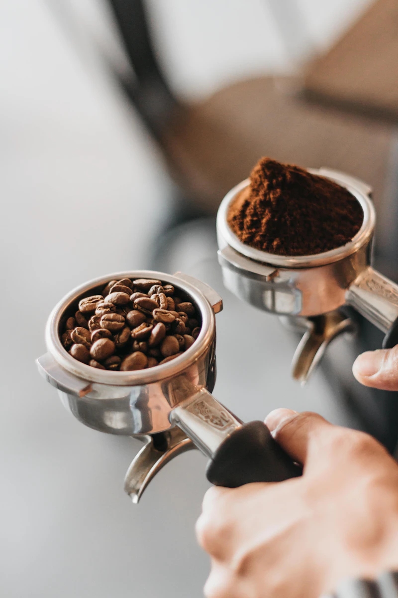 Portafilters filled with roasted coffee beans and grounds