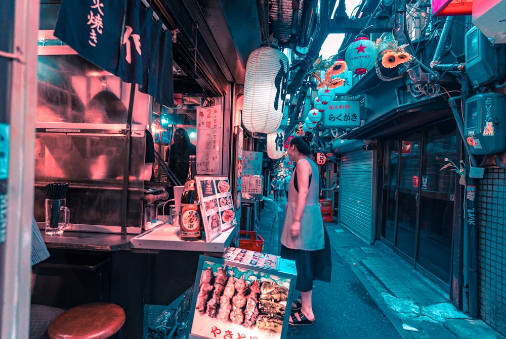 woman standing facing store front