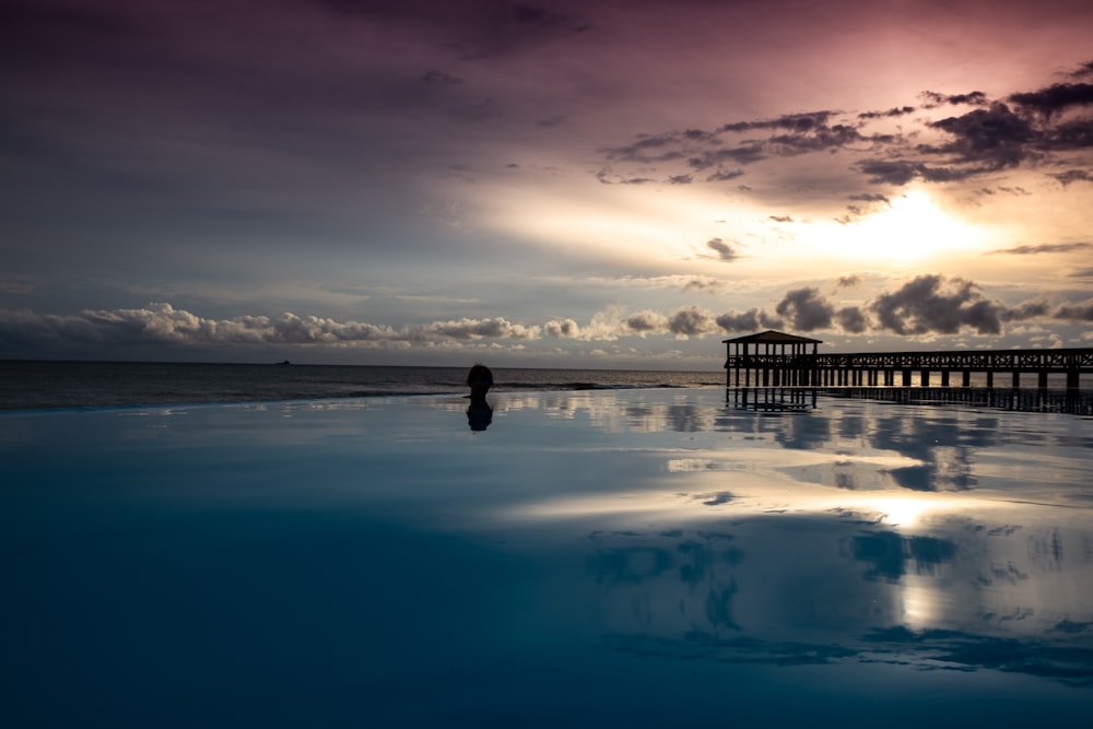 dock on water during sunset