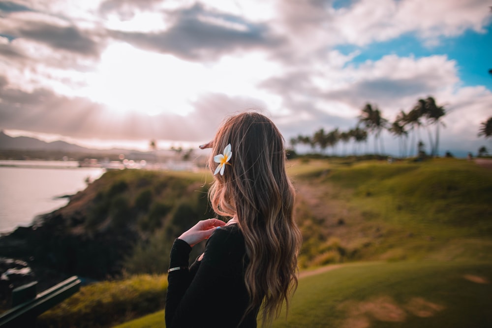 woman facing sea under gloomy sky