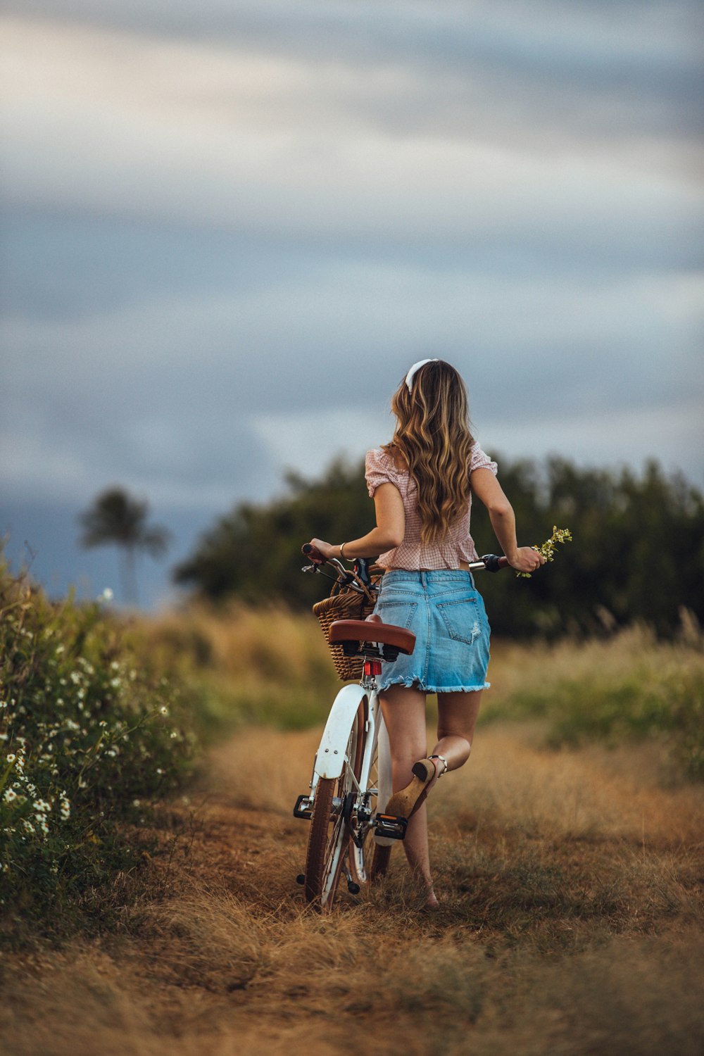 Donna che tiene la bici bianca e marrone