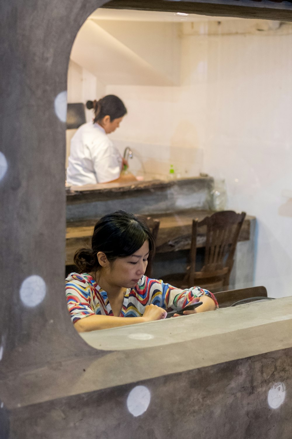 woman using Android smartphone in restaurant